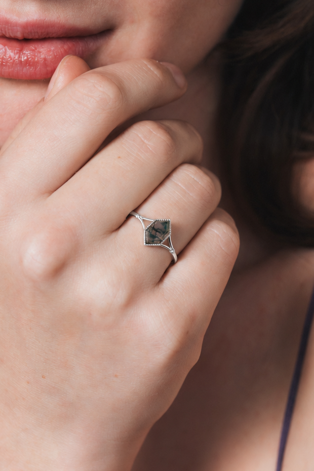 Moss agate ring with green inclusions on delicate silver band.