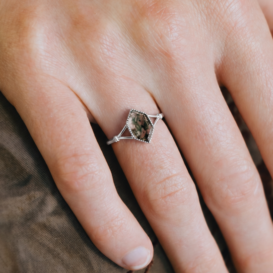 Moss agate ring with green inclusions on delicate silver band.