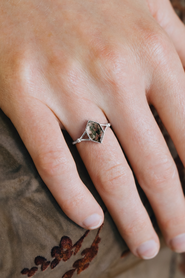 Moss agate ring with green inclusions on delicate silver band.