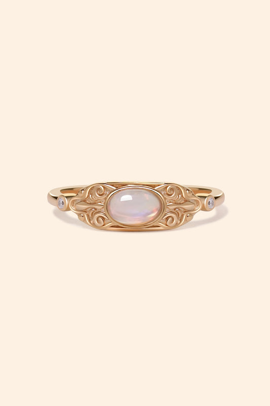 LIRAE vintage-style gold ring with an oval opal center stone and intricate golden swirl filigree, ethereal romantic jewelry for women.