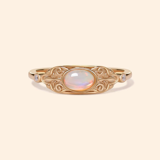 LIRAE vintage-style gold ring with an oval opal center stone and intricate golden swirl filigree, ethereal romantic jewelry for women.