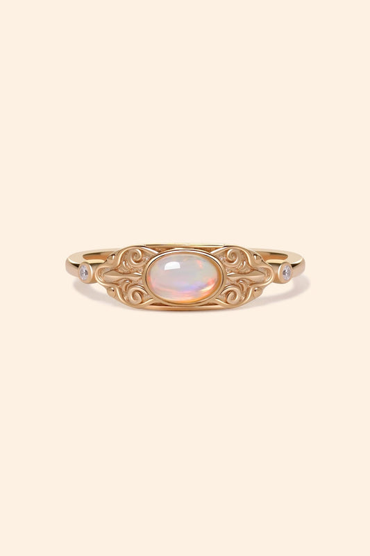LIRAE vintage-style gold ring with an oval opal center stone and intricate golden swirl filigree, ethereal romantic jewelry for women.