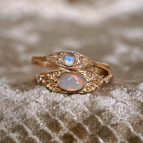 LIRAE vintage-style gold ring with an oval opal center stone and intricate golden swirl filigree, ethereal romantic jewelry for women.