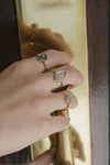 Bold 14k gold oval labradorite statement ring with a central starburst diamond motif and side diamond accents, vintage celestial relic jewelry by LIRAE.