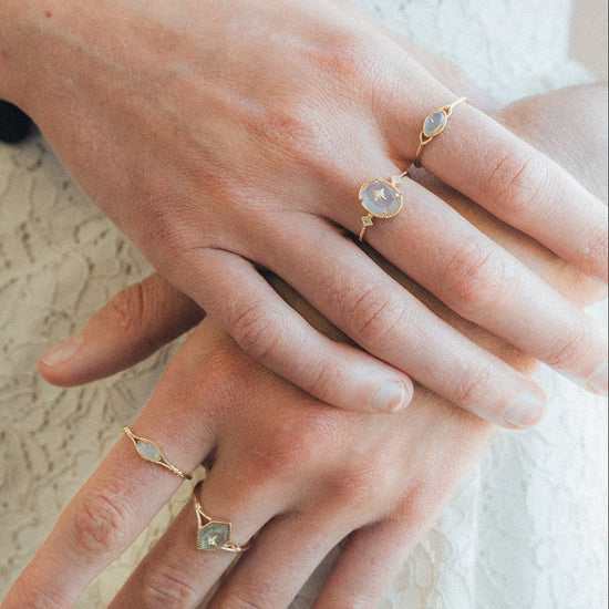 Bold 14k gold oval labradorite statement ring with a central starburst diamond motif and side diamond accents, vintage celestial relic jewelry by LIRAE.