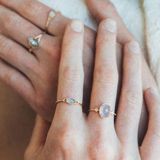 Bold 14k gold oval labradorite statement ring with a central starburst diamond motif and side diamond accents, vintage celestial relic jewelry by LIRAE.
