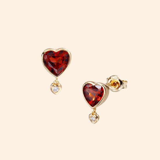 LIRAE vintage style gold heart earrings featuring heart-shaped garnet and a small diamond heart dangle, romantic jewelry for women.