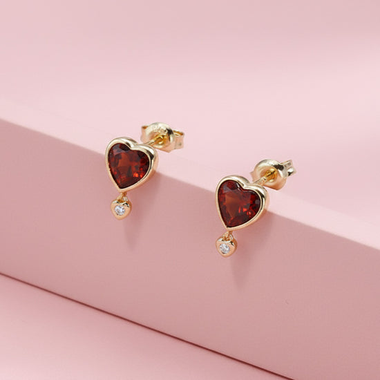 LIRAE vintage style gold heart earrings featuring heart-shaped garnet and a small diamond heart dangle, romantic jewelry for women.