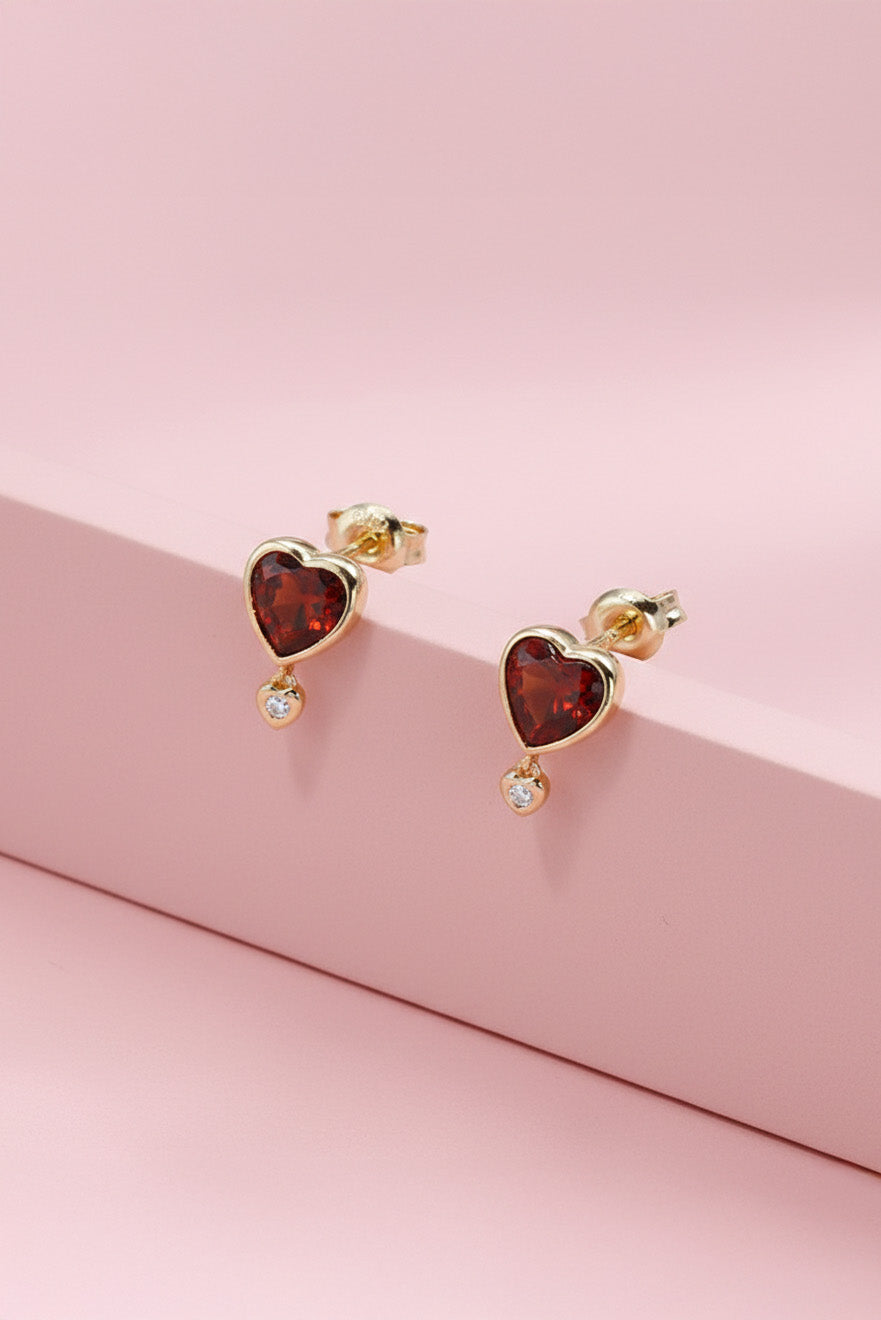LIRAE vintage style gold heart earrings featuring heart-shaped garnet and a small diamond heart dangle, romantic jewelry for women.