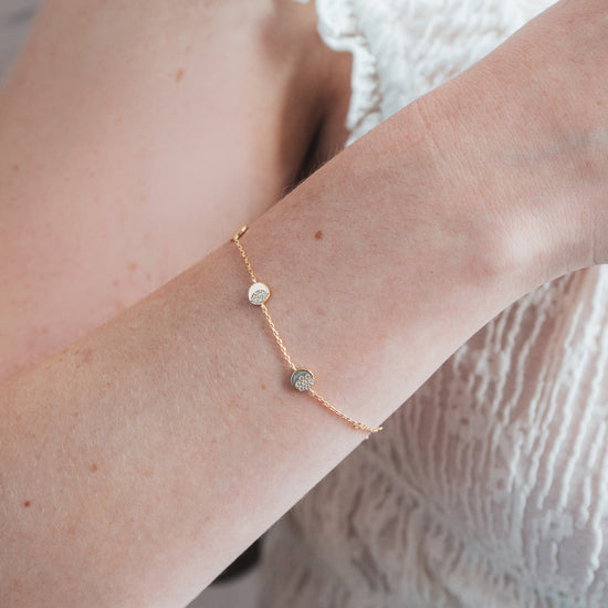 Dainty gold pavé moon phase bracelet with sparkling moon charms