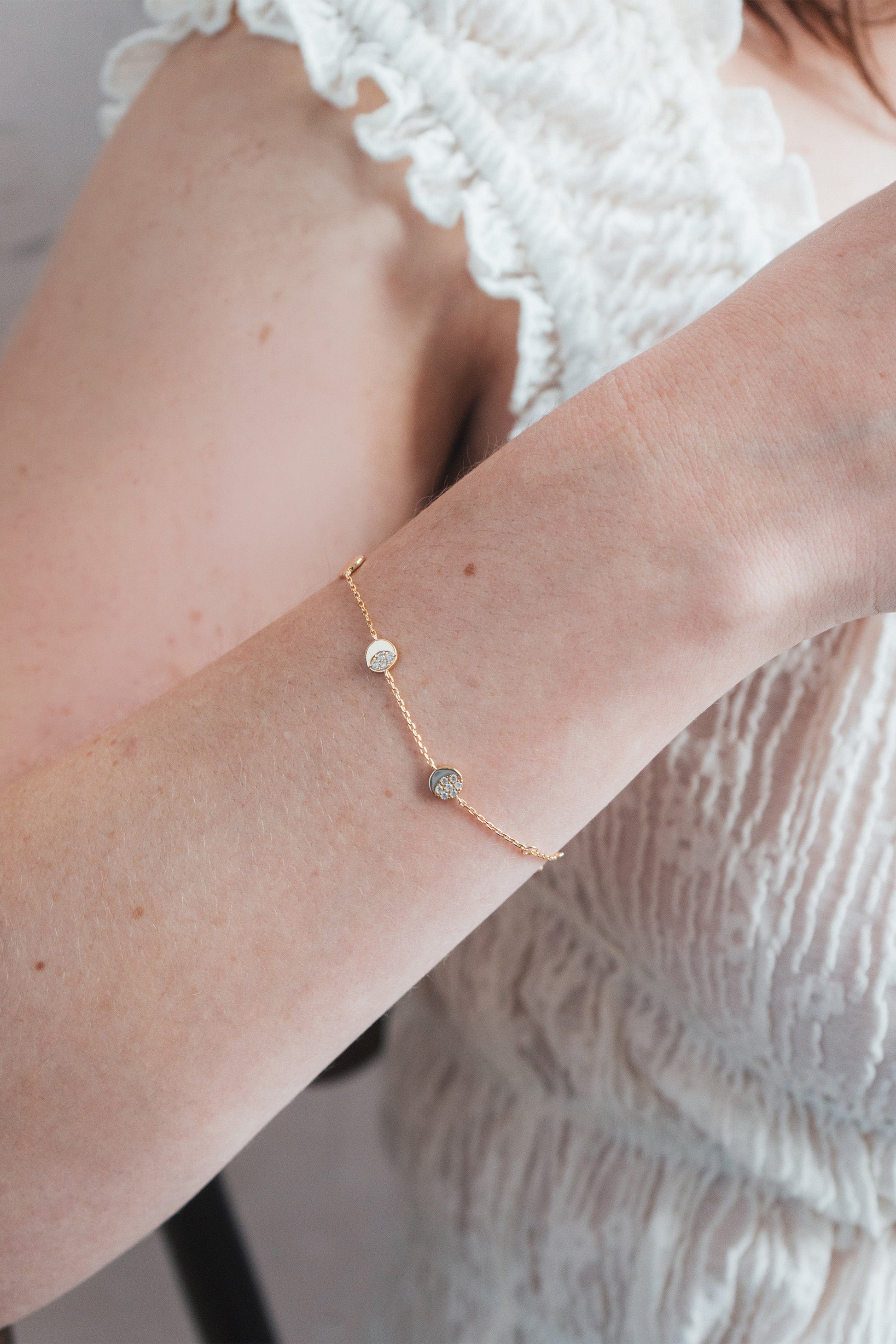Dainty gold pavé moon phase bracelet with sparkling moon charms