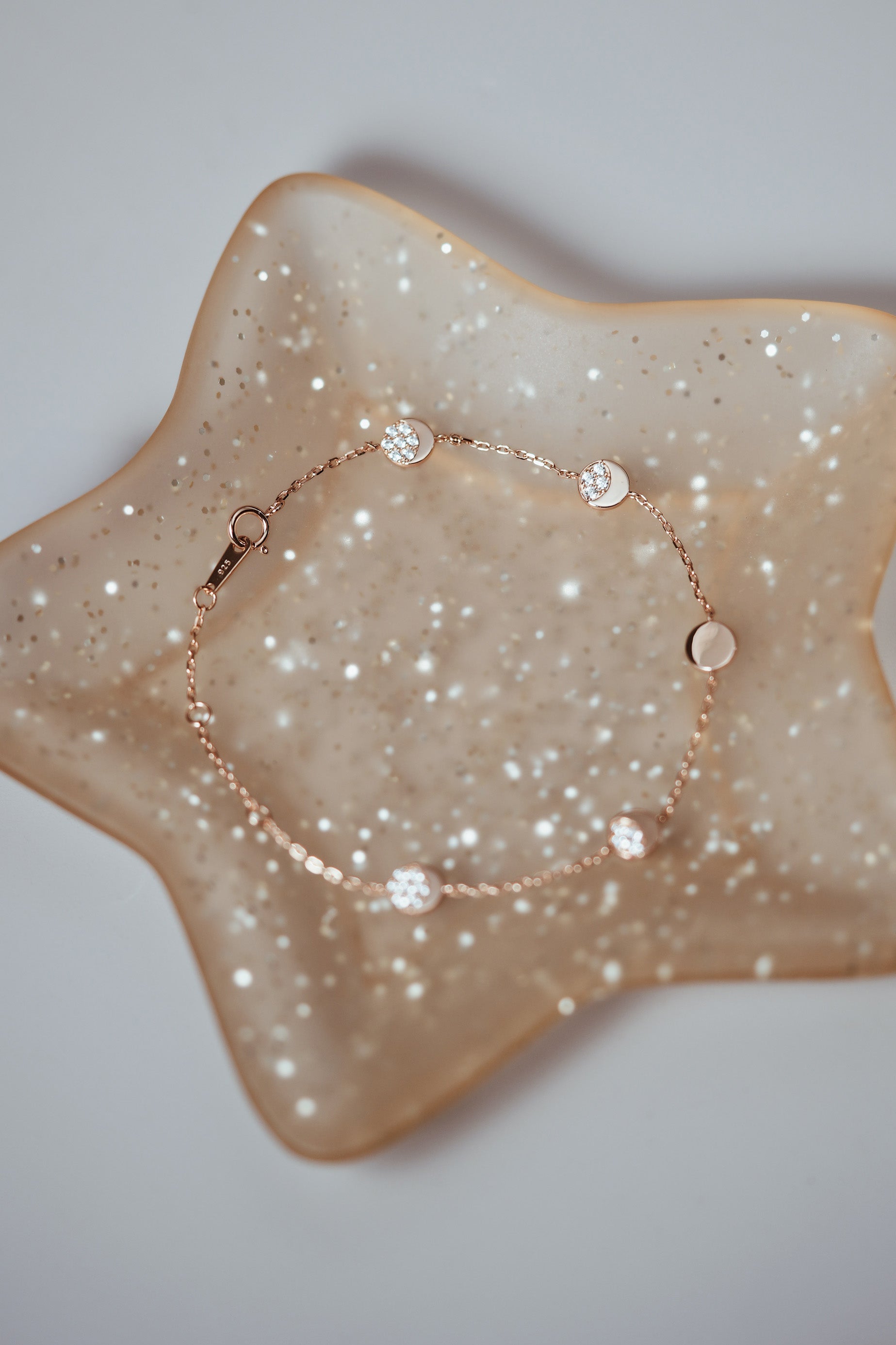 Dainty gold pavé moon phase bracelet with sparkling moon charms