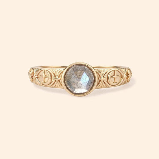 Gold celestial labradorite ring with round center stone and engraved star and moon details