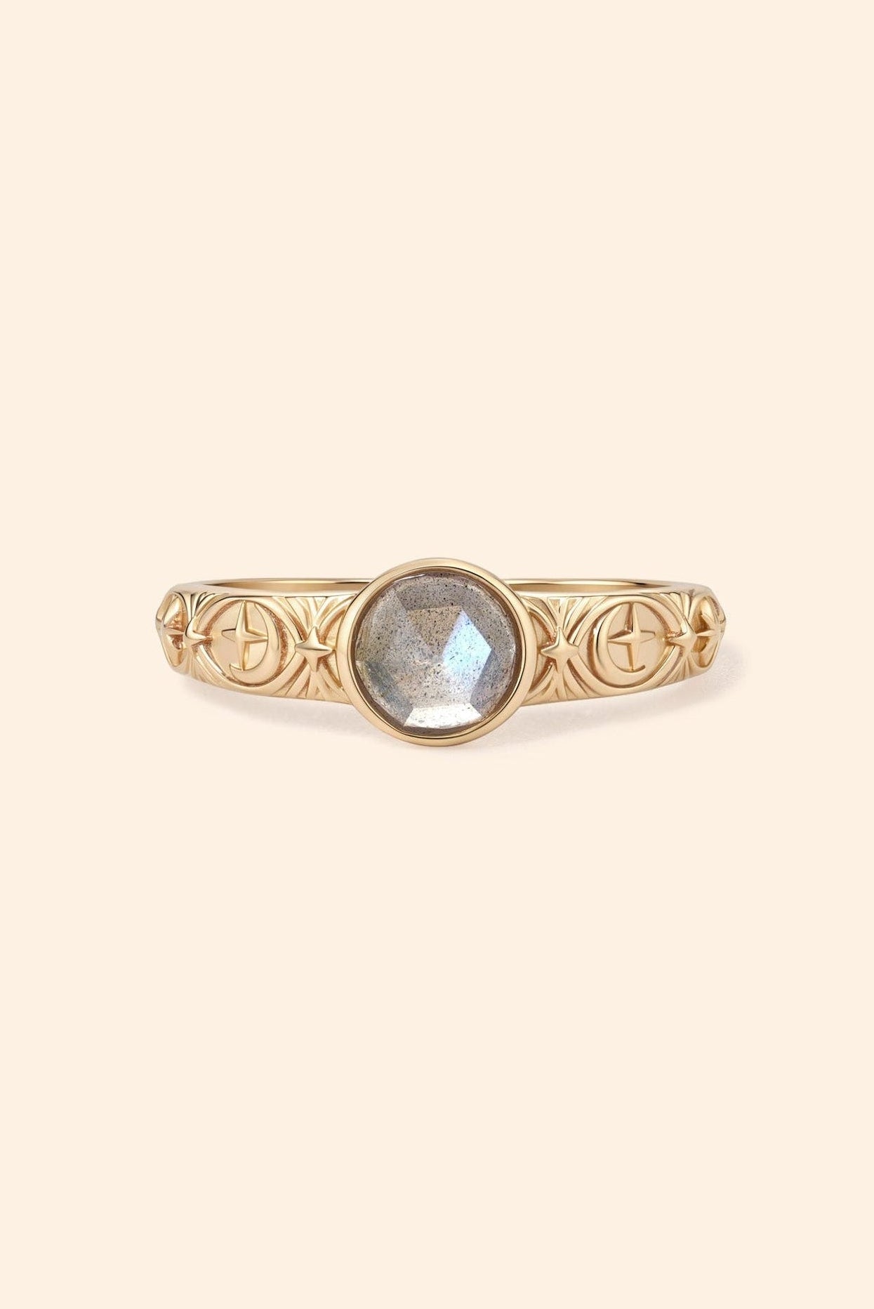 Gold celestial labradorite ring with round center stone and engraved star and moon details
