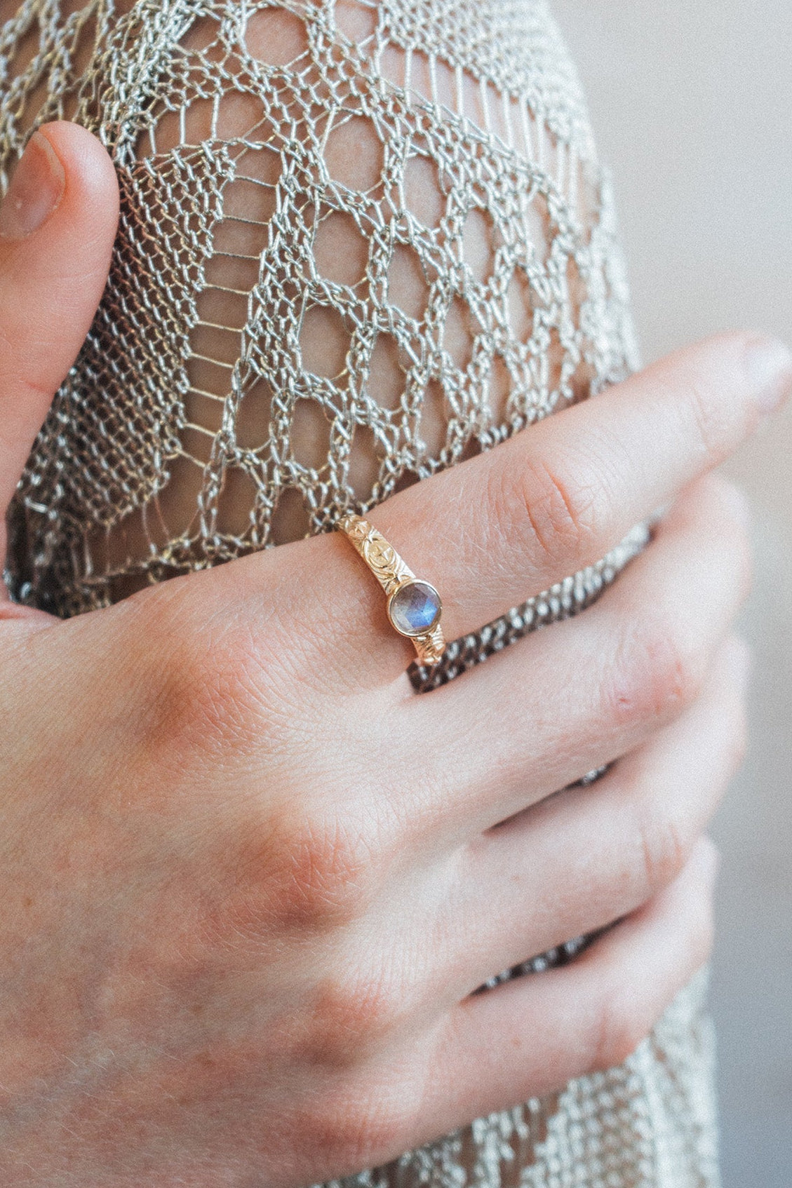 Gold celestial labradorite ring with round center stone and engraved star and moon details