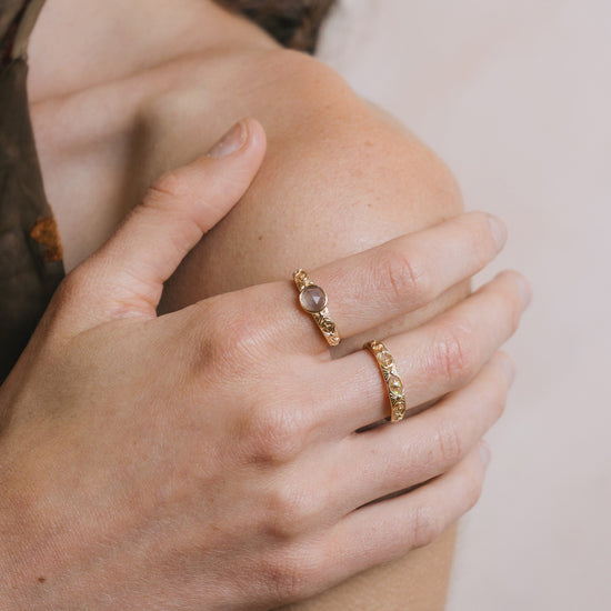 Gold celestial labradorite ring with round center stone and engraved star and moon details