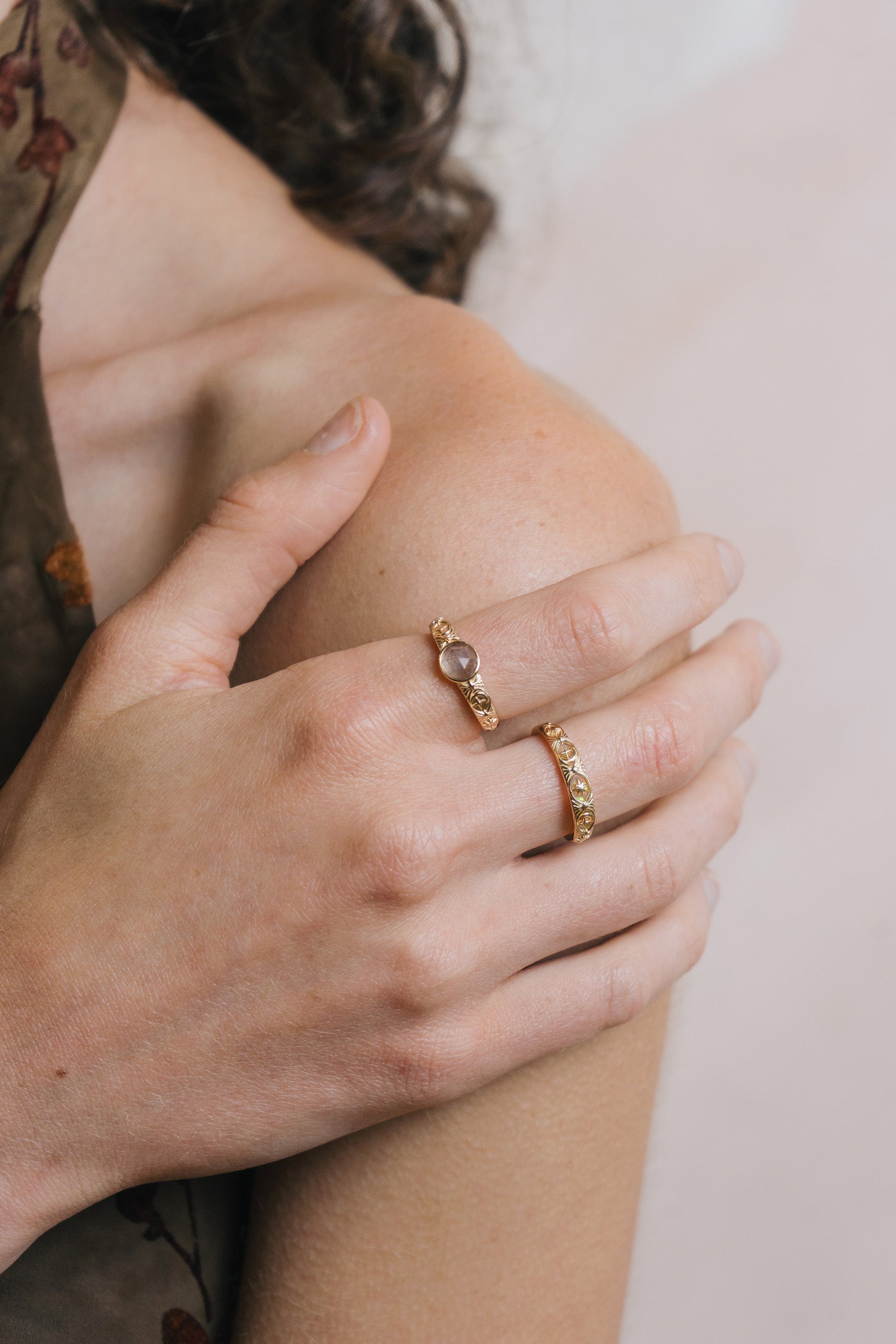 Gold celestial labradorite ring with round center stone and engraved star and moon details
