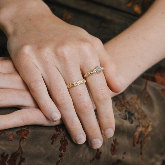 Gold celestial labradorite ring with round center stone and engraved star and moon details