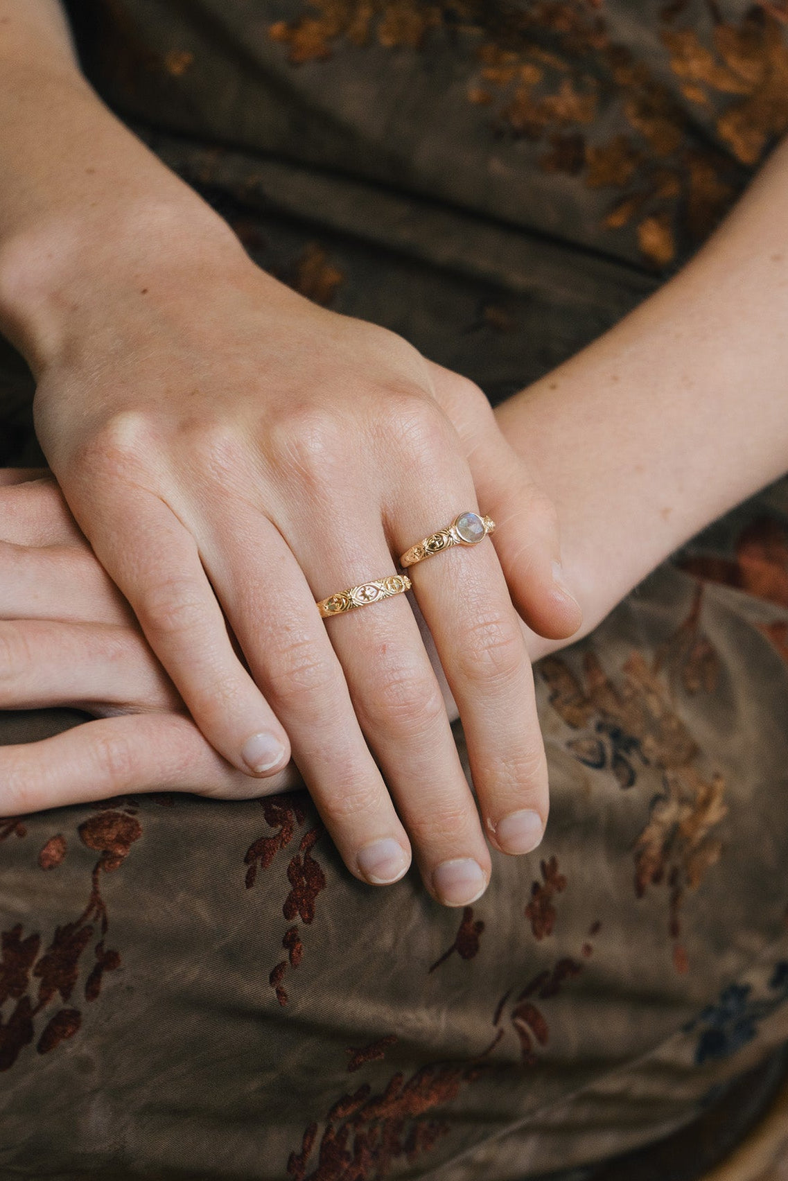 Gold celestial labradorite ring with round center stone and engraved star and moon details