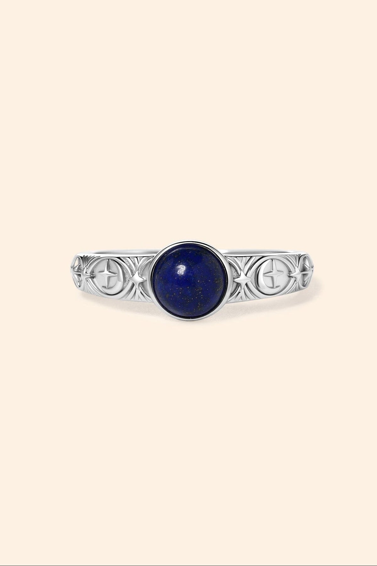 Silver celestial lapis lazuli ring with round blue center stone and engraved moon and star details
