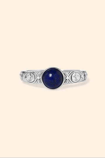 Silver celestial lapis lazuli ring with round blue center stone and engraved moon and star details