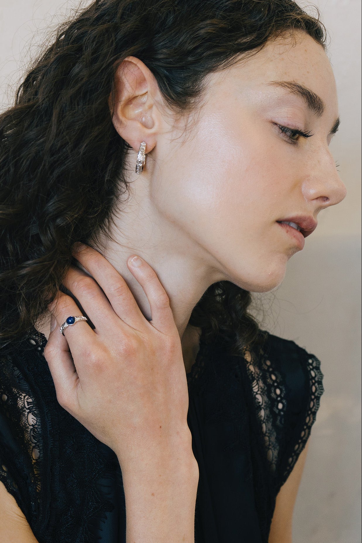 Silver celestial lapis lazuli ring with round blue center stone and engraved moon and star details
