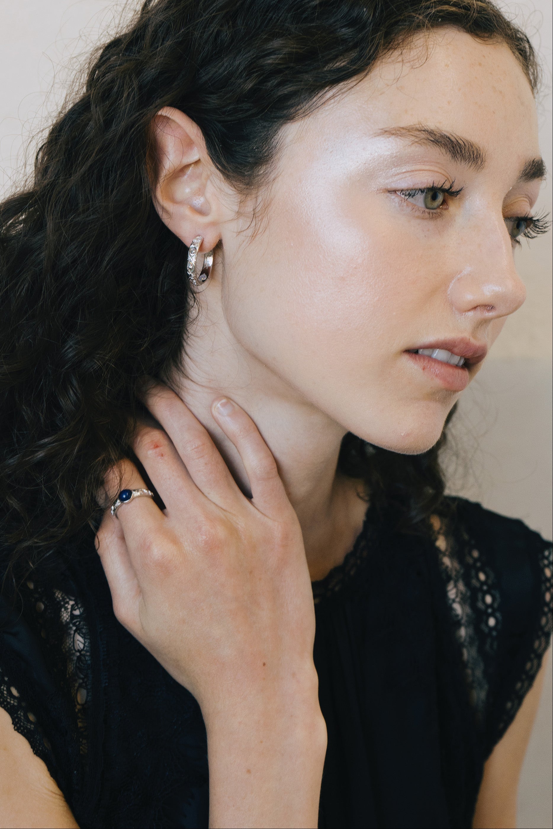 Silver celestial lapis lazuli ring with round blue center stone and engraved moon and star details