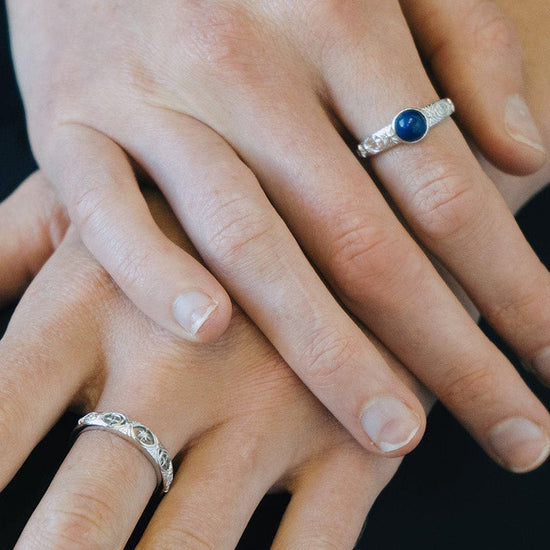 Silver celestial lapis lazuli ring with round blue center stone and engraved moon and star details
