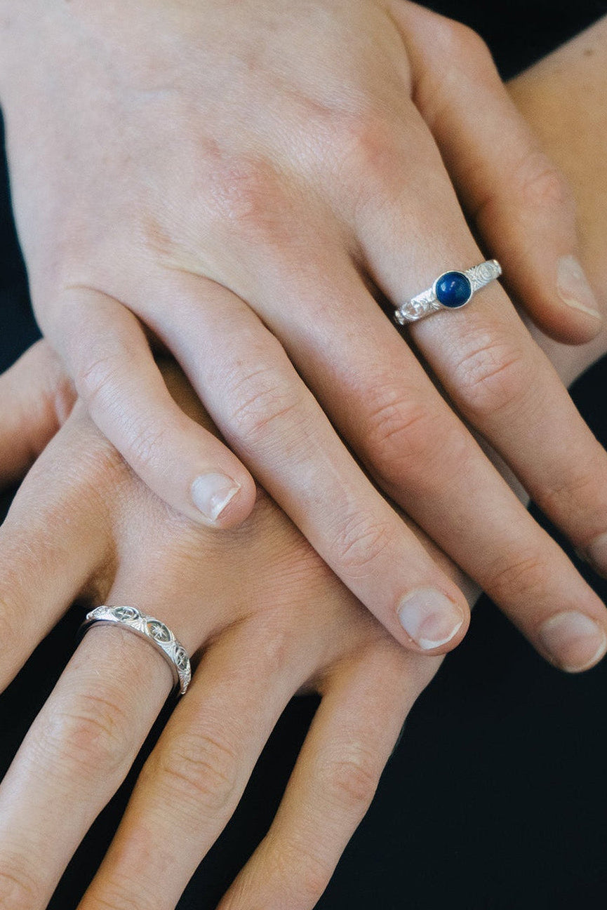 Silver celestial lapis lazuli ring with round blue center stone and engraved moon and star details