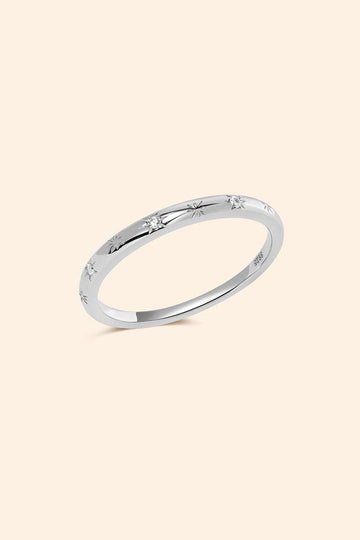 Silver ring with starburst engravings, celestial jewelry by LIRAE.