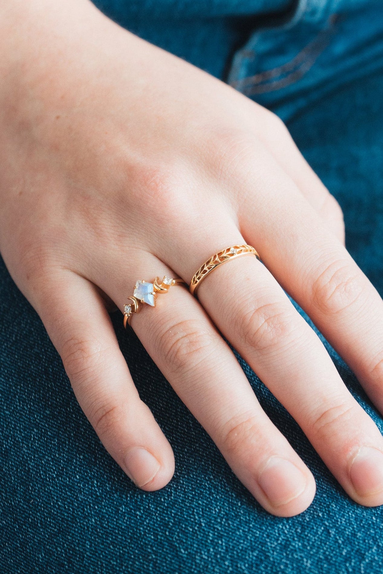 Intricately hollowed gold eternity band with a central starburst diamond, celestial stacking ring by LIRAE.