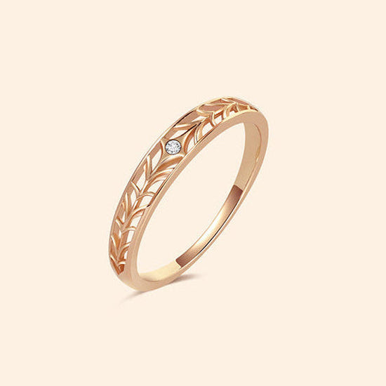 Intricately hollowed gold eternity band with a central starburst diamond, celestial stacking ring by LIRAE.