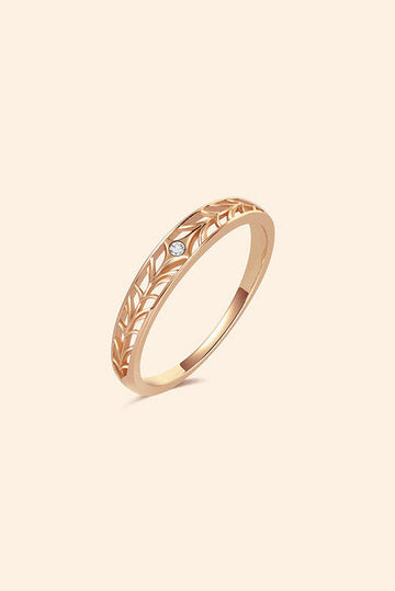 Intricately hollowed gold eternity band with a central starburst diamond, celestial stacking ring by LIRAE.