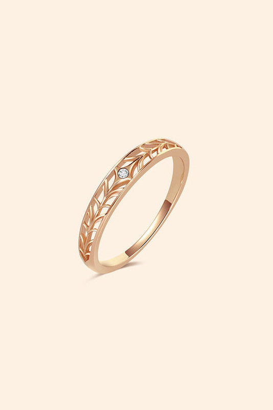 Intricately hollowed gold eternity band with a central starburst diamond, celestial stacking ring by LIRAE.
