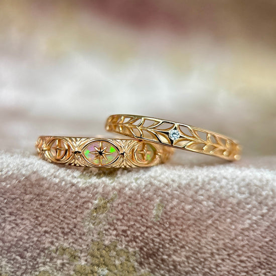 Intricately hollowed 14k gold eternity band with a central starburst diamond, celestial stacking ring by LIRAE.