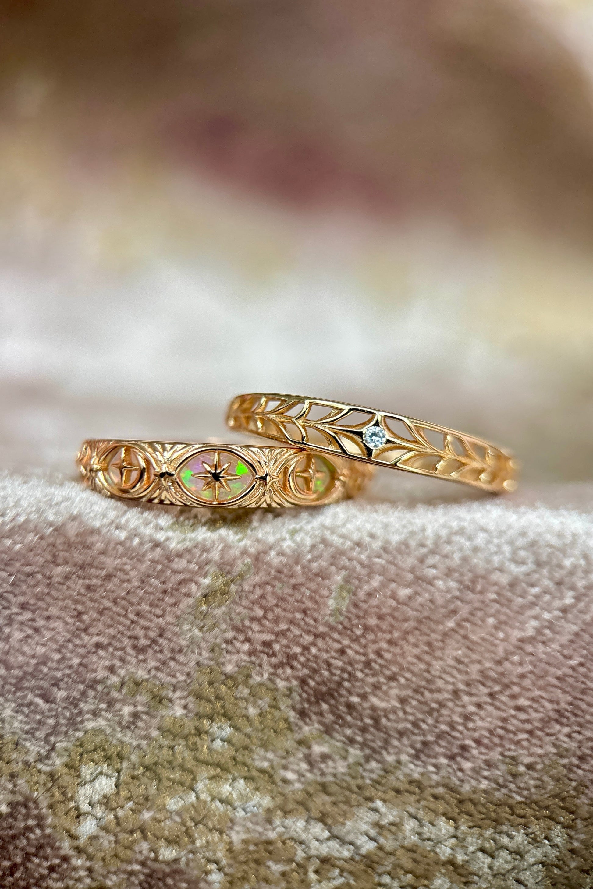 Intricately hollowed 14k gold eternity band with a central starburst diamond, celestial stacking ring by LIRAE.