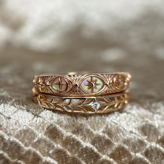 Intricately hollowed 14k gold eternity band with a central starburst diamond, celestial stacking ring by LIRAE.