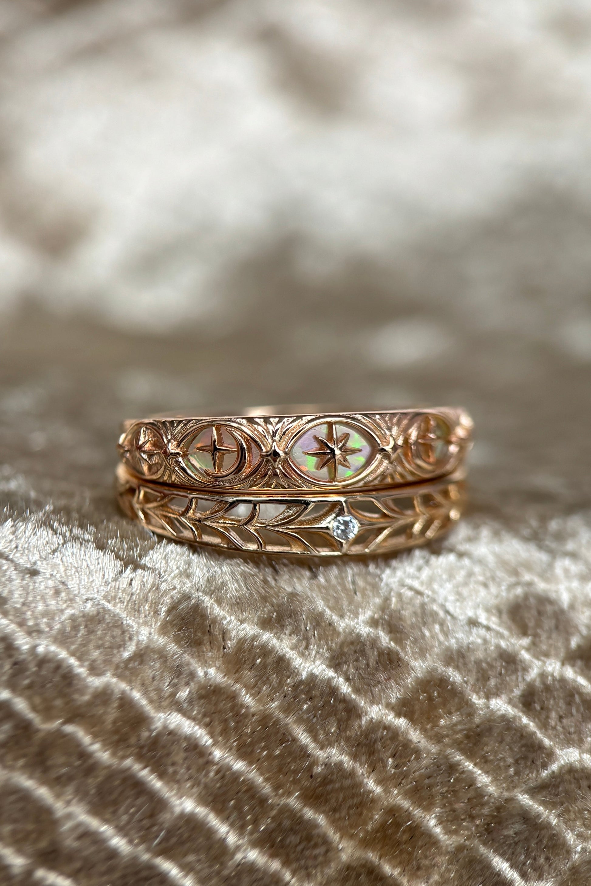 Intricately hollowed 14k gold eternity band with a central starburst diamond, celestial stacking ring by LIRAE.
