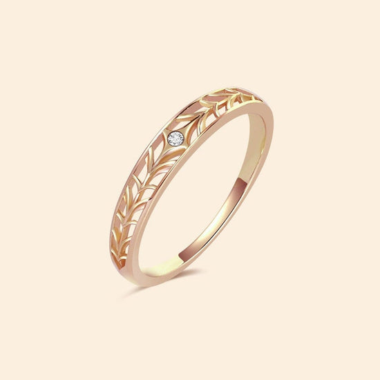 Intricately hollowed 14k gold eternity band with a central starburst diamond, celestial stacking ring by LIRAE.