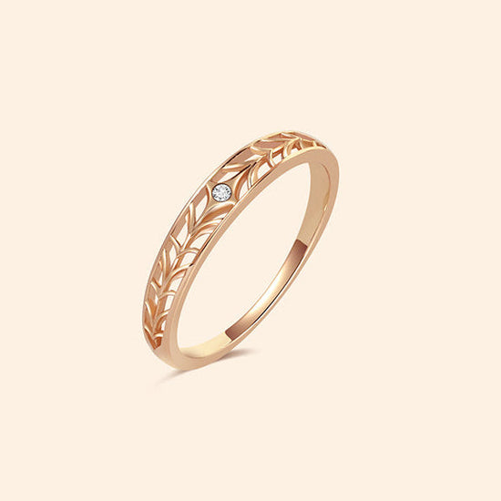 Intricately hollowed 14k gold eternity band with a central starburst diamond, celestial stacking ring by LIRAE.