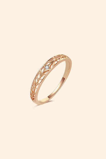 Intricately hollowed 14k gold eternity band with a central starburst diamond, celestial stacking ring by LIRAE.
