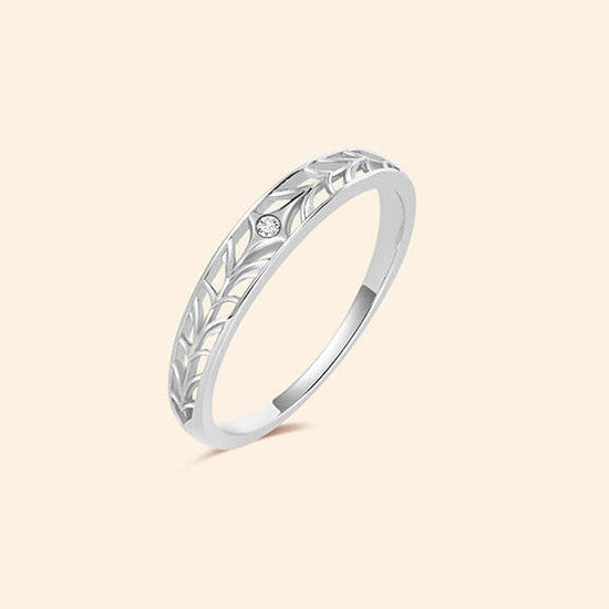 Intricately hollowed silver eternity band with a central starburst moissanite, celestial stacking ring by LIRAE.