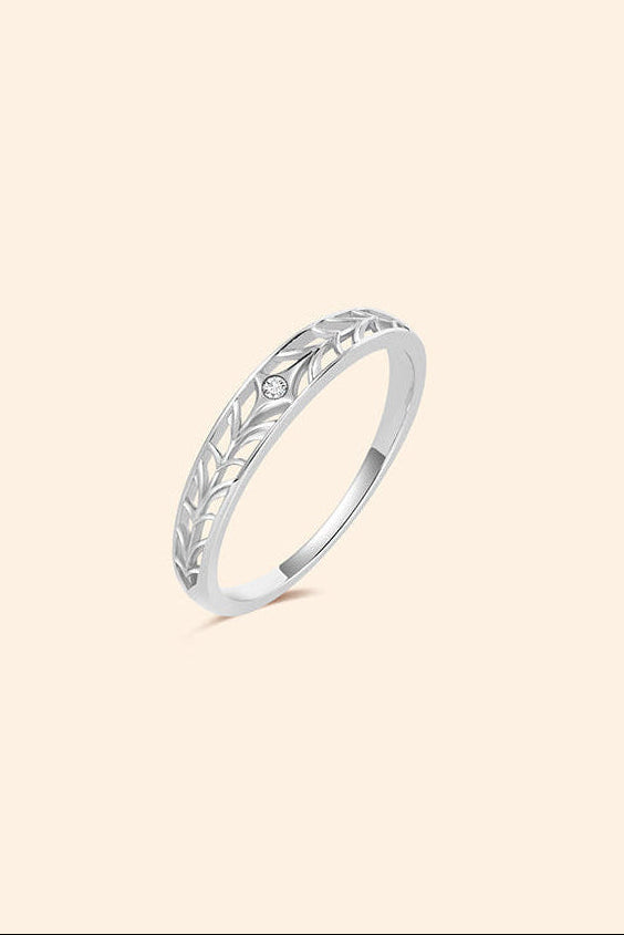 Intricately hollowed silver eternity band with a central starburst moissanite, celestial stacking ring by LIRAE.