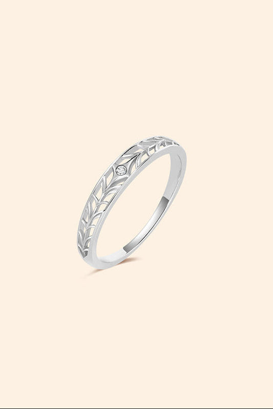 Intricately hollowed silver eternity band with a central starburst moissanite, celestial stacking ring by LIRAE.