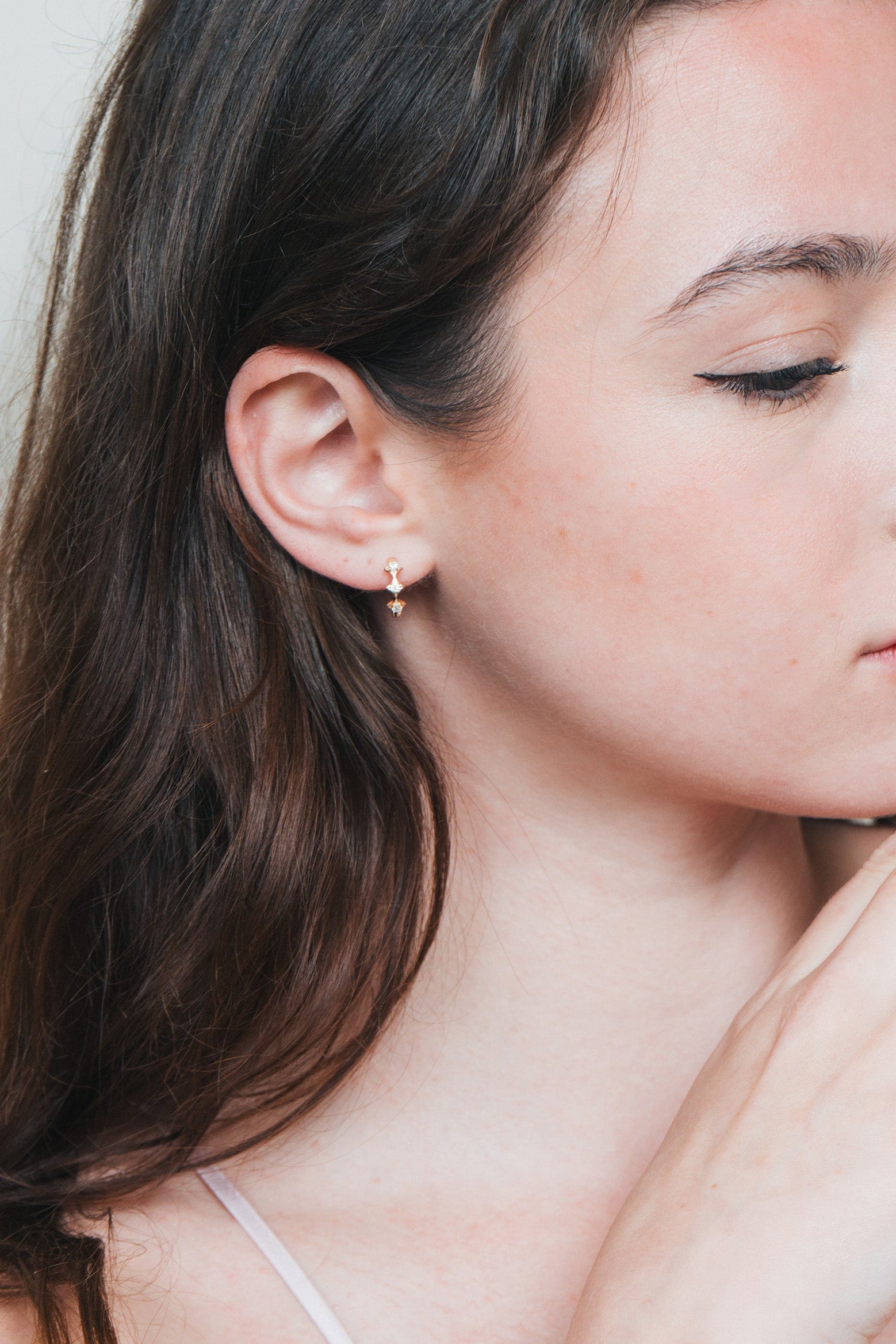 Dainty gold starlight huggie hoop earrings with sparkling moissanite by LIRAE