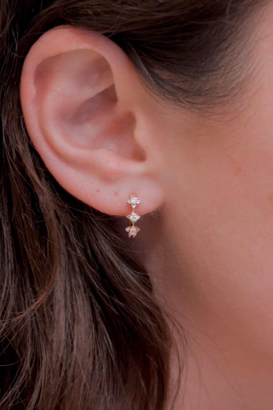 Dainty gold starlight huggie hoop earrings with sparkling moissanite by LIRAE