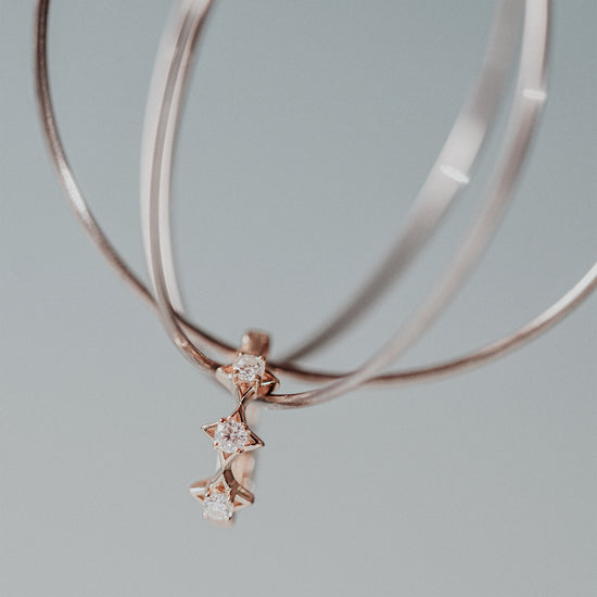 Dainty gold starlight huggie hoop earrings with sparkling moissanite by LIRAE