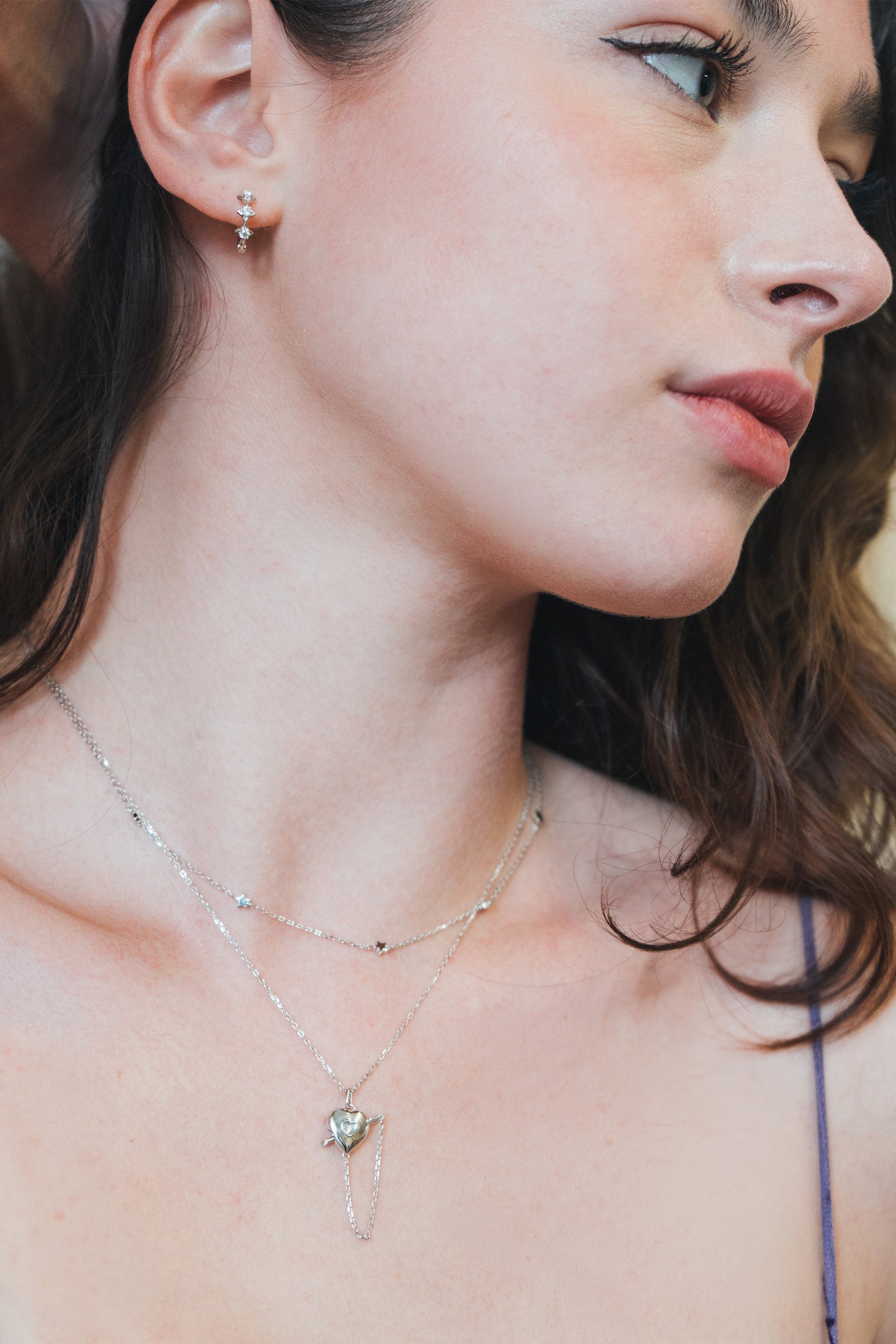 Dainty silver starlight huggie hoop earrings with sparkling moissanites by LIRAE