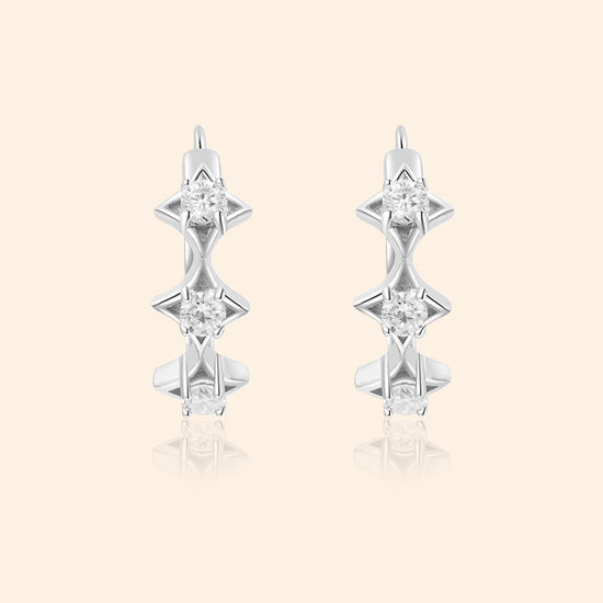 Dainty silver starlight huggie hoop earrings with sparkling moissanites by LIRAE
