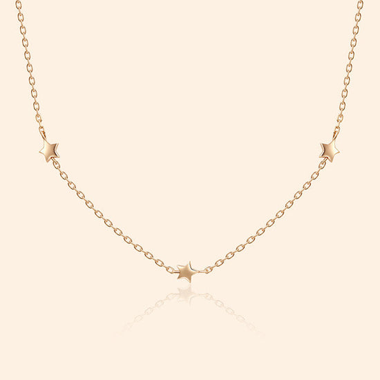 Dainty gold star necklace with scattered star charms